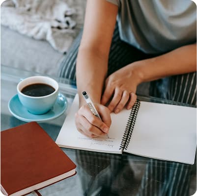 Person writing on paper – smart tax optimisation using Bonsai affordable investing app